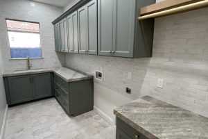 Celadon Green Laundry Room with Gold Hardware