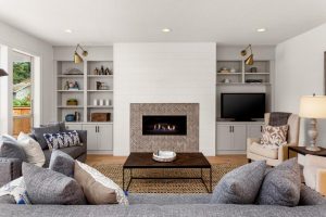 Entertainment - Cozy family room with gray built ins by shiplap fireplace