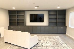Entertainment - Gray built-in cabinets and shelves with TV opening