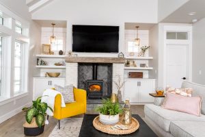 Entertainment - White cabinets and floating shelves by TV and fireplace