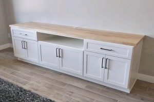 Entertainment - White console with wood countertop and matte black handles