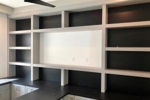 Home Office - Gray built in wall unit with desk and TV opening