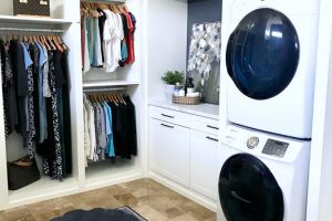 Laundry Room - Luxury white closet with built in hampers and stackable washer and dryer