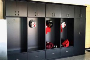 Mudroom and Seating - Black lockers in garage with cabinets, hooks, bench seats and drawers
