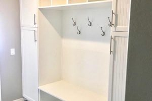 Mudroom and Seating - White bench with shoe cubbies, hooks, and cabinets