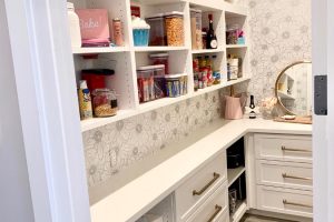 Pantry & Bar - Organized white pantry with drawers and wallpaper