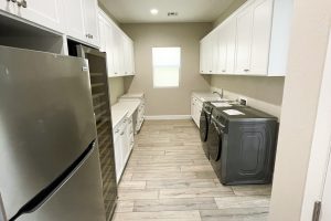 Shaker Style Laundry Room with Built-In Fridge 2