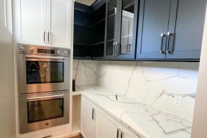 Two-Toned Pantry Cabinetry Built Around Ovens